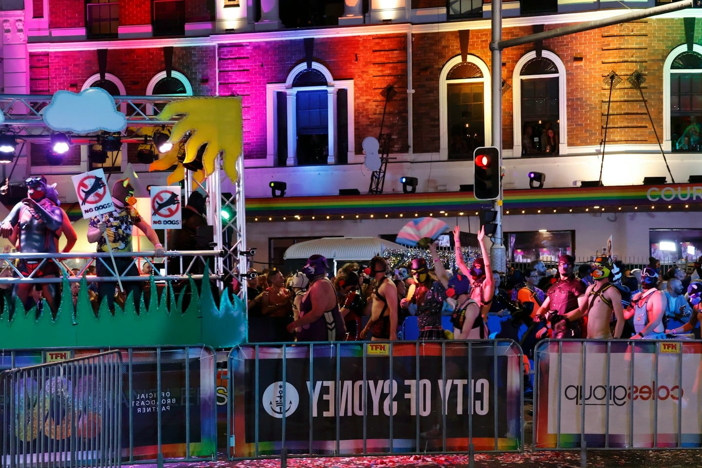 People in costumes and animal masks celebrate during a street parade.